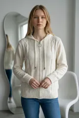 Campera tipo sweater de chenille con textura suave, cierre frontal con tirador circular, capucha con cordones ajustables y puños y ruedo acanalados.