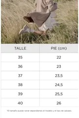 Sandalias planas Paddock modelo Talua, de color beige con diseño de tiras cruzadas estilo romano y hebilla lateral ajustable.