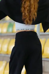 Pantalón negro de gabardina elastizada, corte sastrero, tiro bajo y pierna ancha. Tiene bolsillos delanteros, botón metálico con logo RENÉE y tajo en el lateral interno.