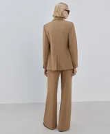 Pantalon de vestir color tostado, de corte recto y tiro medio, con bolsillos laterales y cierre frontal.