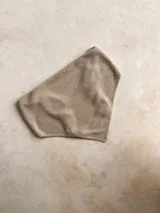 Bandana o turbante de punto fino color beige claro, con textura brillante o metalizada.