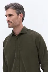 Camisa de pana de algodón con cuello clásico, cierre frontal de botones y mangas largas. Presenta un diseño de corte regular con textura suave y acabado mate.