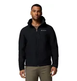 Chaqueta softshell negra con capucha desmontable, cierre frontal completo y bolsillos con cremallera. Presenta logo de la marca bordado en el pecho y puños ajustables.