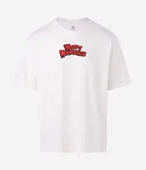 Remera boxy de algodón color blanco, con cuello redondo y mangas cortas. Presenta un estampado grande en la espalda del personaje El Pájaro Loco, con su nombre en rojo y un fondo azul y amarillo, y un globo de diálogo que dice "Guess Who?".