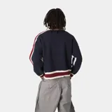 Campera de tejido de punto azul marino, corte oversize, con cierre frontal y cuello polo. Presenta detalles en tejido acanalado de color bordó y blanco en cuello, puños y ruedo. Las mangas tienen franjas decorativas en blanco y bordó. El frente lleva bordado el texto "EMEST UDIOS" en blanco.