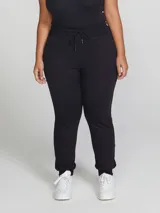 Pantalón babucha de algodón color negro, con cintura elástica con cordón ajustable y puños en los tobillos.