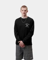 Remera de manga larga Carhartt WIP modelo L/S Eightynine Waffle T-Shirt, de color negro con textura tipo waffle. Cuenta con cuello redondo y diseño de estampado bordado en el pecho con texto en color blanco.