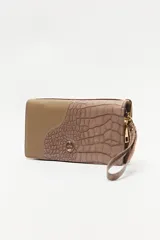 Billetera de mano con textura efecto cocodrilo, color beige, con cierre perimetral y tira de muñeca desmontable.