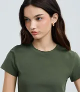 Blusa femenina de corte cropped, color verde oliva, con cuello redondo y mangas cortas. Confeccionada en algodón con elastano, ofrece un ajuste cómodo y versátil.