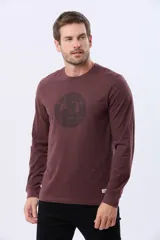 Remera de algodón de manga larga color bordó, con cuello redondo y estampado circular en el pecho con el texto "LIFE IS GOOD HAPPY CAMPER Legacy" y un diseño de montañas y árboles.