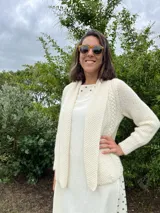 Cardigan tejido a mano color crudo, con solapa en el escote y punto delicado.