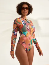 Malla entera de manga larga con estampado tropical multicolor y cierre frontal con cremallera.