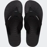 Ojotas Havaianas Surfer Coast de color negro, con tiras de tela texturizada y suela con diseño ondulado.