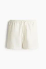 Short de lino y viscosa color beige, de corte relajado, con cintura elástica y cordón ajustable.