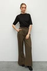 Remera negra de cuello redondo y manga tres cuartos, confeccionada en tela con textura sutil. Presenta fruncidos laterales que aportan caída y movimiento a la prenda.