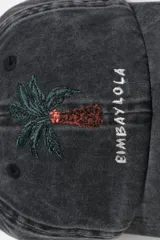 Gorra gris oscuro con efecto lavado, con diseño bordado de una palmera y el texto 'Bimba y Lola' en la parte frontal.