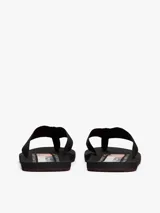 Ojotas negras con suela de EVA y tiras de tejido trenzado en color negro. Presentan un logo bordado en la tira del dedo.