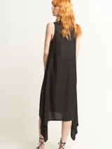 Vestido negro con escote en V y corte irregular con picos en los costados. Incluye lazo de algodón a tono para ajustar en la cintura.