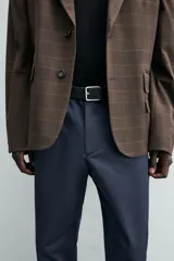 Pantalón chino de corte regular fit, confeccionado en tejido de algodón con elasticidad. Presenta bolsillos frontales, bolsillos traseros de vivo y cierre frontal con cremallera y botón.