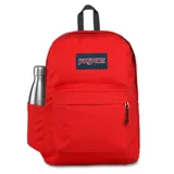 Mochila Jansport SuperBreak Plus color rojo, con logo de la marca en el frente, asa superior y tirantes acolchados. Incluye un compartimento principal, bolsillo frontal con organizador, funda interna para laptop de 15" y bolsillo lateral para botella de agua.