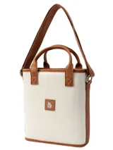 Matera modelo Cadiz con diseño a rayas en tonos beige, blanco y marrón, asas cortas de mano y correa larga ajustable para el hombro.