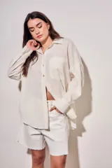 Camisa oversize de lino y viscosa color celeste, con cuello clásico, cierre frontal con botones y mangas largas.