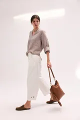 Blusa de lino color lila, de corte relajado y mangas largas amplias, con escote en V y ruedo curvo.