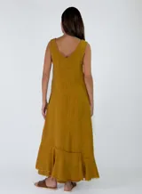 Vestido largo sin mangas, con escote en V, corte holgado y detalles de volados con flecos en el ruedo.