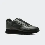Championes Reebok Glide de color negro, confeccionados en cuero sintético, con diseño clásico de perfil bajo, cordones al tono y suela de goma amortiguada.