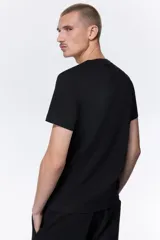 Remera H&M de corte ajustado, confeccionada en punto de algodón liviano, con cuello redondo ribeteado y bajo recto.