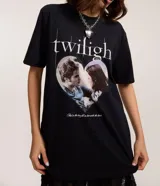 Remera de manga corta color negro, corte oversize, con cuello redondo. Presenta un estampado frontal inspirado en la película Twilight, con el título y una imagen de Bella y Edward dentro de un corazón.