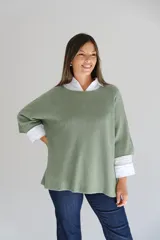 Sweater de punto color verde, con cuello redondo, mangas tres cuartos y diseño holgado.