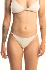 Bombacha de bikini color crudo, con corte clásico y laterales con detalle de aros metálicos.