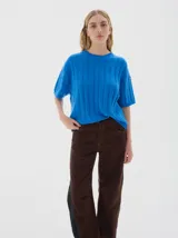 Buzo tejido de manga corta color rojo, con cuello redondo y diseño de punto acanalado y trenzado.