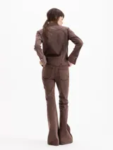 Pantalón de mezclilla marrón chocolate, de tiro medio y corte flare con perneras ligeramente acampanadas y costuras verticales decorativas en el frente.