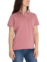 Remera tipo polo color rosa, de piqué, con mangas cortas, cuello camisero y logo de pato bordado en el pecho.