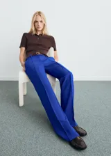 Pantalón de tiro medio color azul, con diseño recto y largo, trabillas para cinturón y cierre oculto con botón, gancho y cremallera.