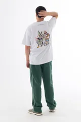 Remera blanca de algodón con cuello redondo y mangas cortas. Estampado en la espalda con ilustración de personajes de Dragon Ball Z intervenidos por el artista coreano Lonely Weirdo Club.