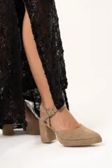 Sandalias de tacón color visón con puntera triangular y tira con hebilla al tobillo.