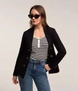 Blazer negro de mujer, cruzado, con solapas y botones dorados en el frente y puños. Confeccionado en tejido de punto roma.