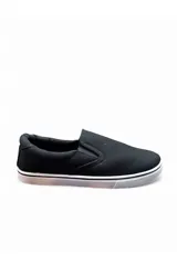 Mocasines tipo slip-on de lona color azul marino con suela blanca de goma y elásticos laterales para facilitar el calce.
