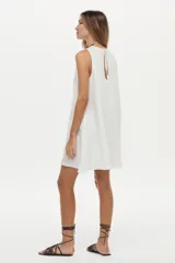 Vestido corto de lino blanco, sin mangas, con cuello redondo y diseño holgado.