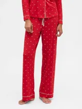 Pantalón de pijama de modal color rojo con estampado de pequeños lazos blancos, corte recto y cintura elástica con cordón de ajuste.