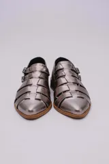 Sandalias bajas de cuero color dorado con tiras entrecruzadas y hebillas ajustables. Taco de madera.