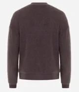 Blusa de pijama manga larga confeccionada en tejido fleece de tacto suave y aspecto peludo. Presenta cuello redondo, puños y ruedo acanalados.