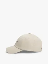 Gorra de béisbol Tommy Jeans de cinco paneles, color beige, con logo bordado en la parte frontal y hebilla de ajuste metálica en la parte trasera.