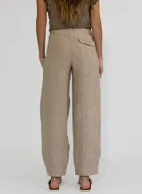 Pantalon de lino color beige, de corte recto y holgado, con cintura alta y ruedo con doblez.
