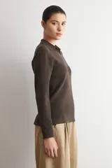 Sweater de punto acanalado color marrón, con cuello polo y escote en V, de manga larga y calce holgado.