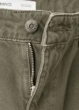 Pantalón cargo de jean color verde militar, de tiro medio, corte ancho y bolsillos laterales con solapa.
