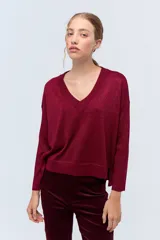 Sweater color borgoña con lurex, escote en V y mangas largas.